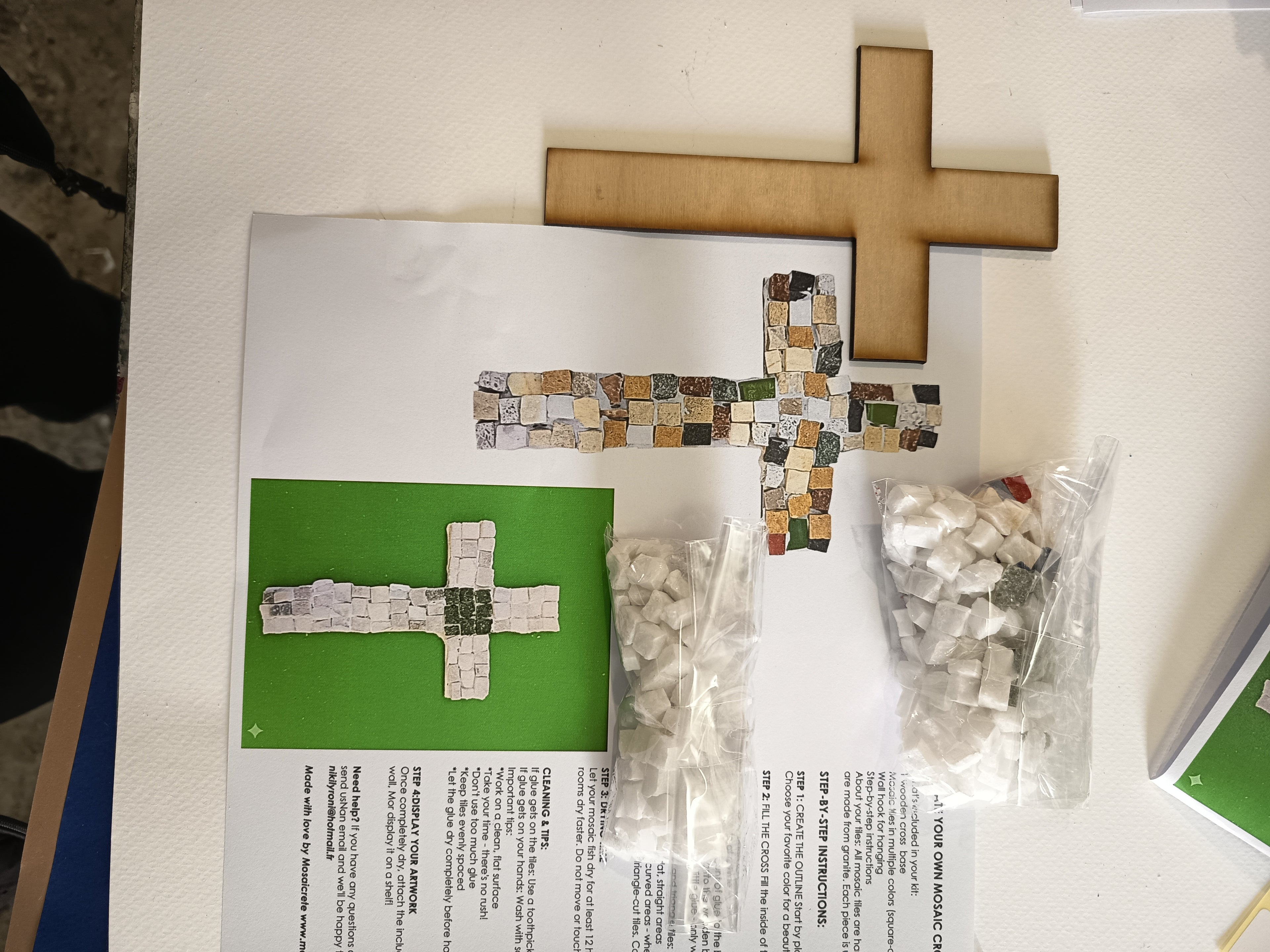 DIY mosaic cross kit - here you can see exactly what you will receive: wooden cross base, hand-cut marble tiles, center tile in your chosen color, glue, wall hook and printed instructions